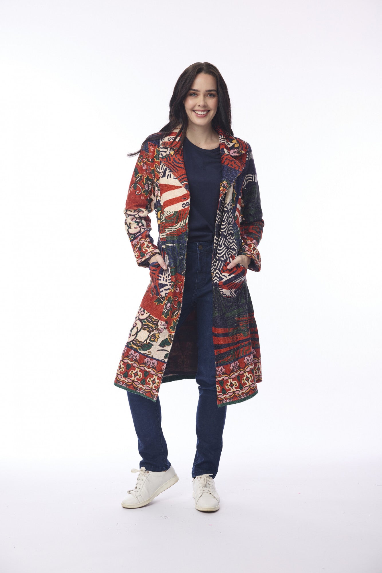 Woman wearing a patterned coat on a white background